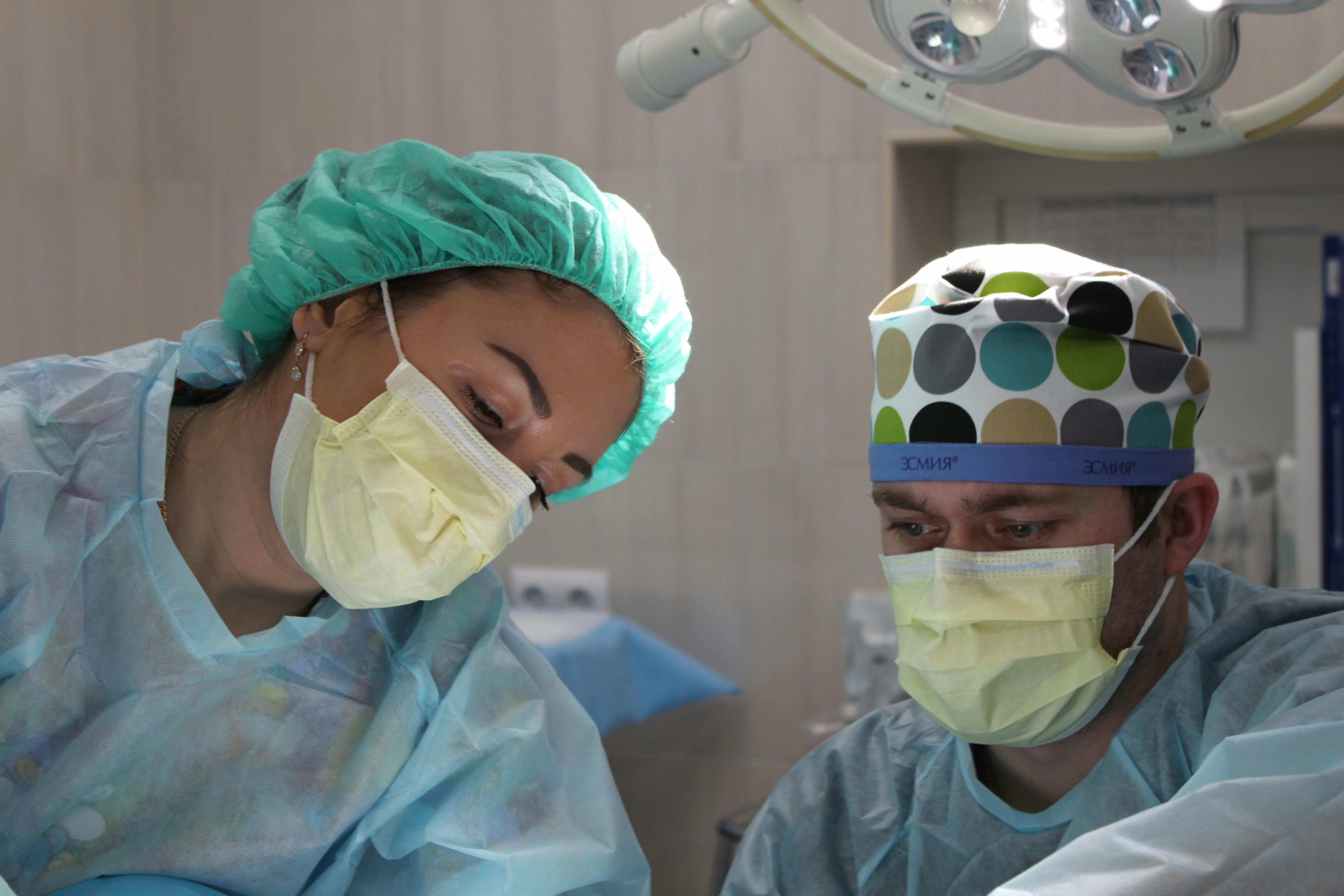 view of doctors at operating table - Transform patient care with custom healthcare software development services. Enhance engagement, streamline workflows, and ensure data security concept