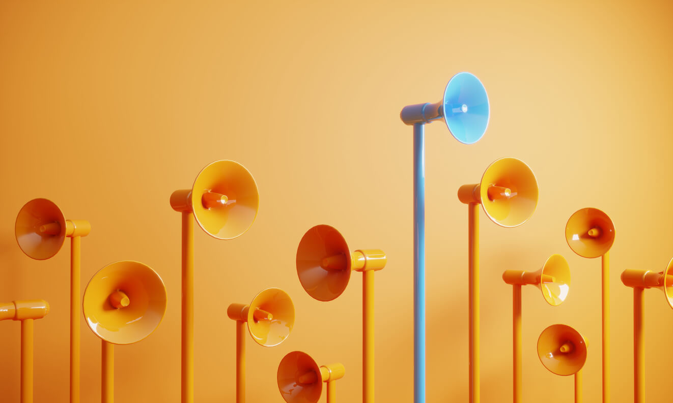 Blue colored megaphone standing out from the crowd - Discover essential lessons from a leading marketing strategy agency to boost your business growth. 
